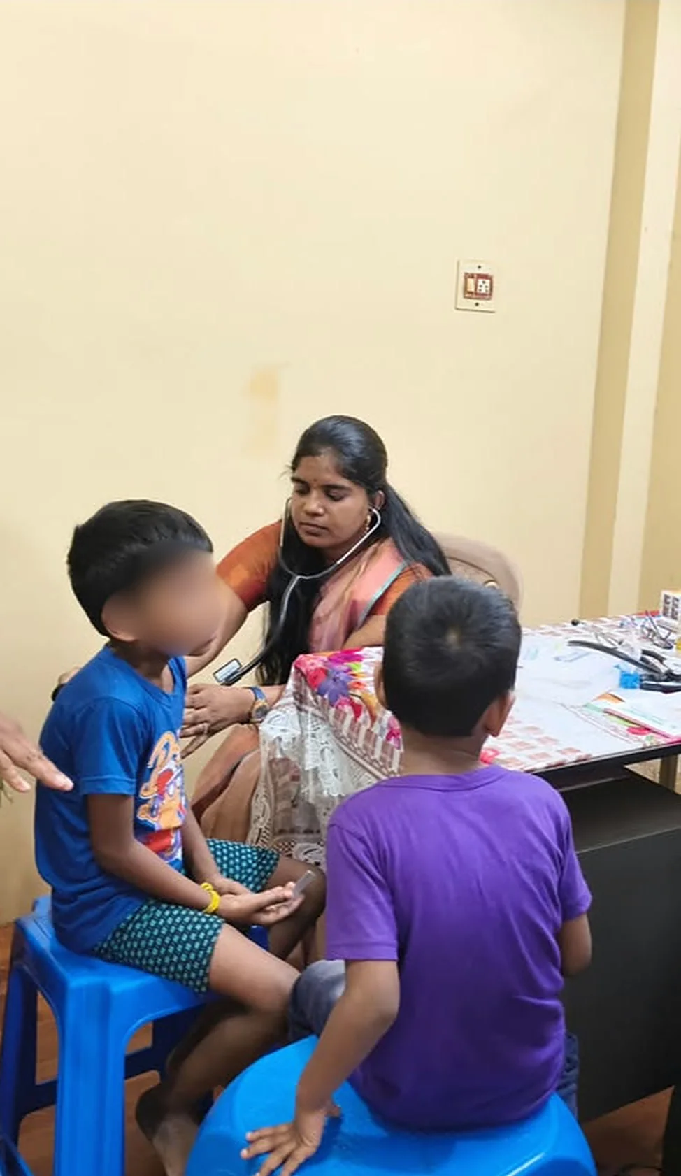 Dr. Inbavalli examining children at a free medical camp